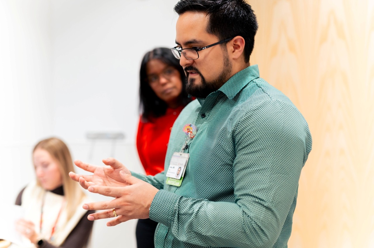 A group of physicians gather to discuss a case. 