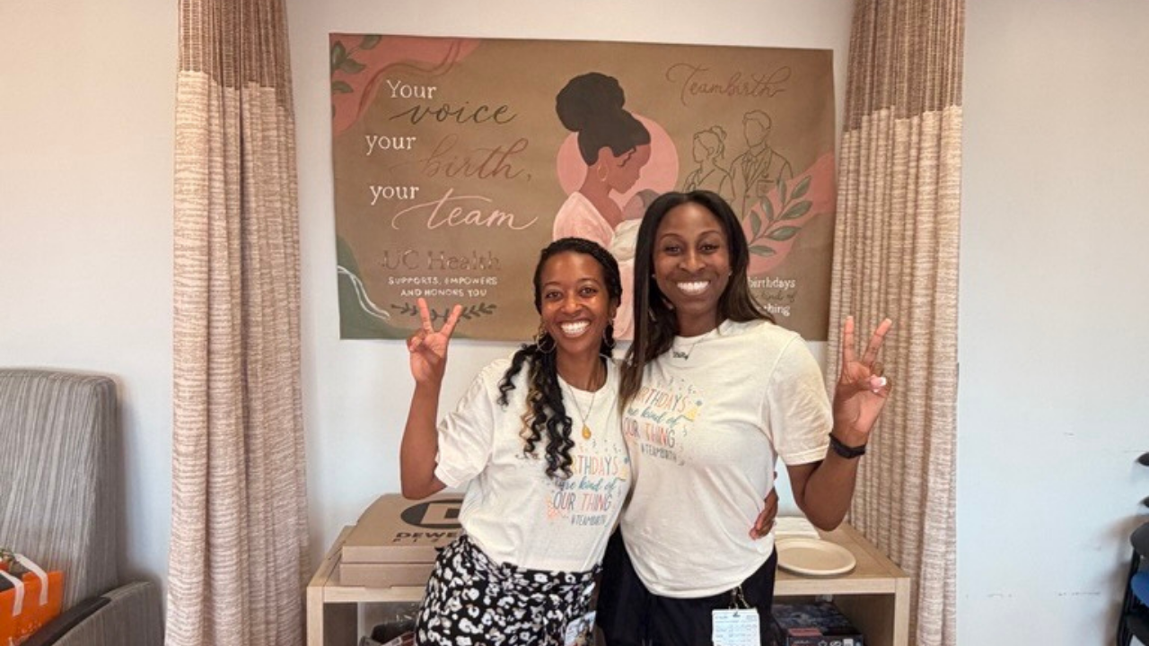 Labor and Delivery team at UC Health in Cincinnati stand by mural promoting Teambirth initative