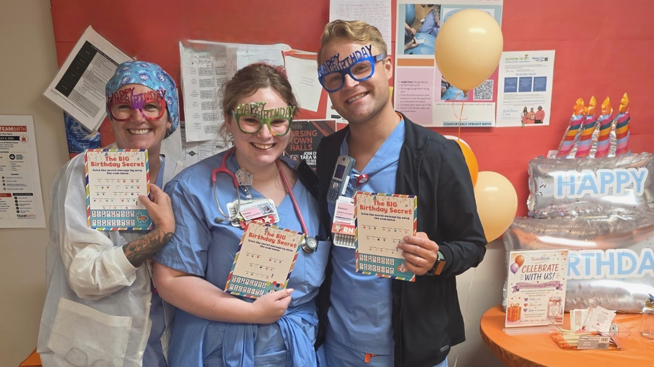 UC Health pregnancy and childbirth team members wear "Happy Birthday" glasses and pose to celebrate launch of a new program..