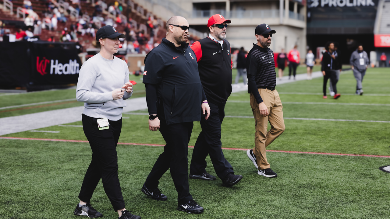 UC Health Ortopaedics & Sports Medicine team on the sidelines at a UC Bearcats football game