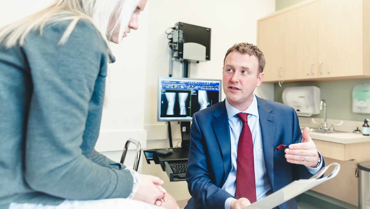 Dr. Grawe at UC Health meets with a patient to review x-rays