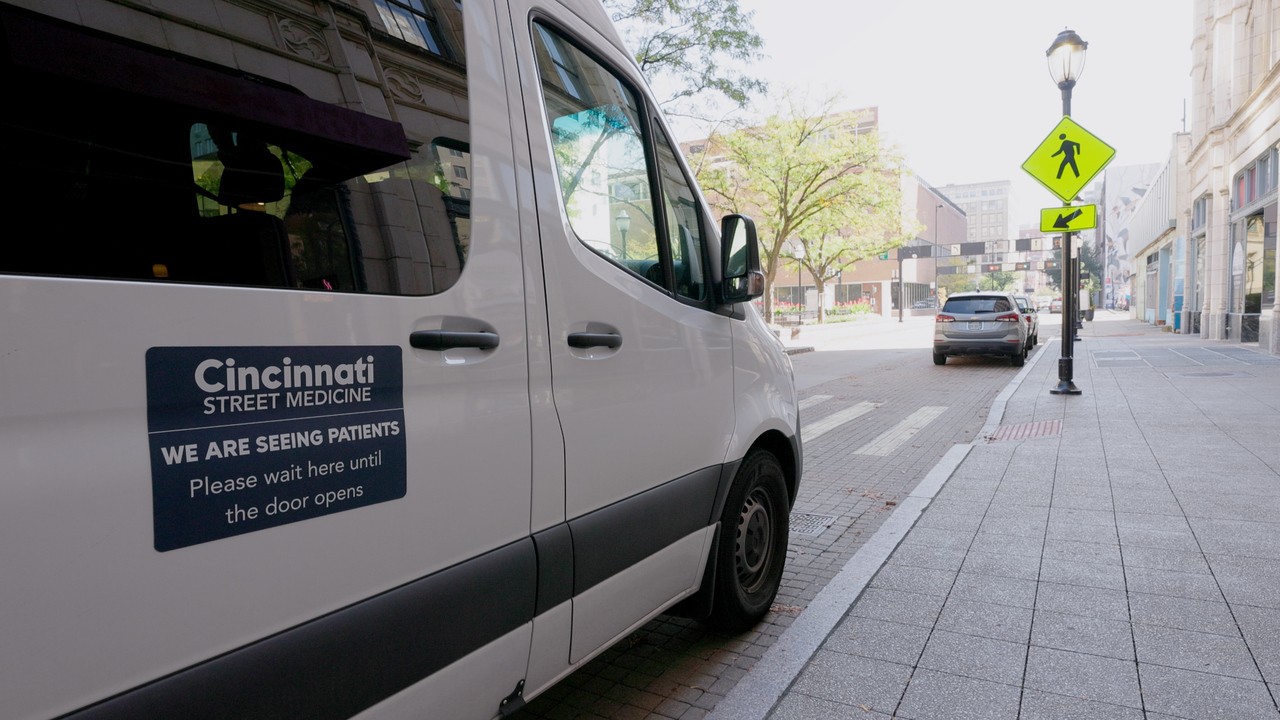 Cincinnati Street Medicine's mobile clinic van. The white Mercedes-Benz Sprinter van is parked on a street in downtown Cincinnati to meet patients where they are. 