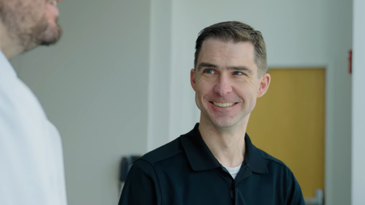 Adam smiles while talking with Dr. Callow at UC Health in Cincinnati