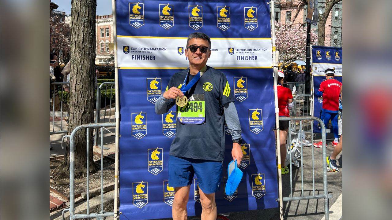 Alex Lui poses with his medal after finishing the 2026 Boston Marathon