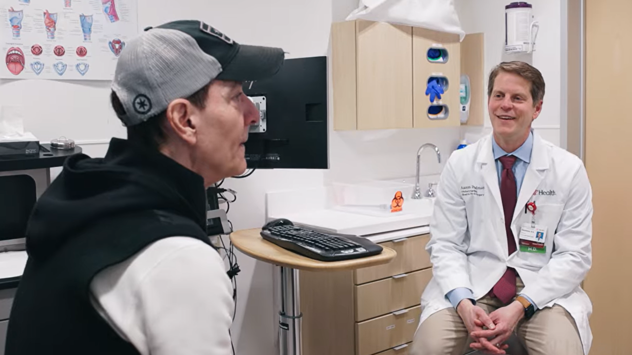 Johnny B talks with Dr. Friedman in an exam room. 