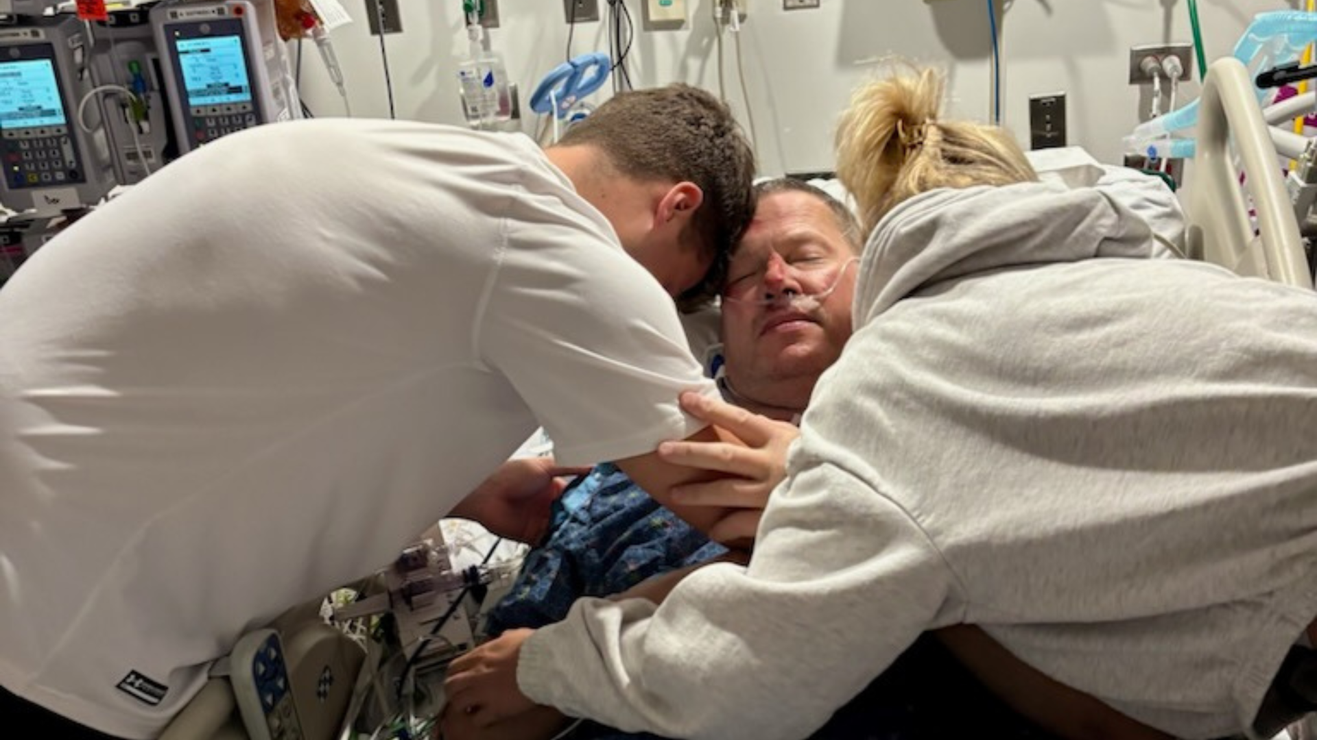 Brian hugging his children in the hospital. Photo provided by Brian Hopton.