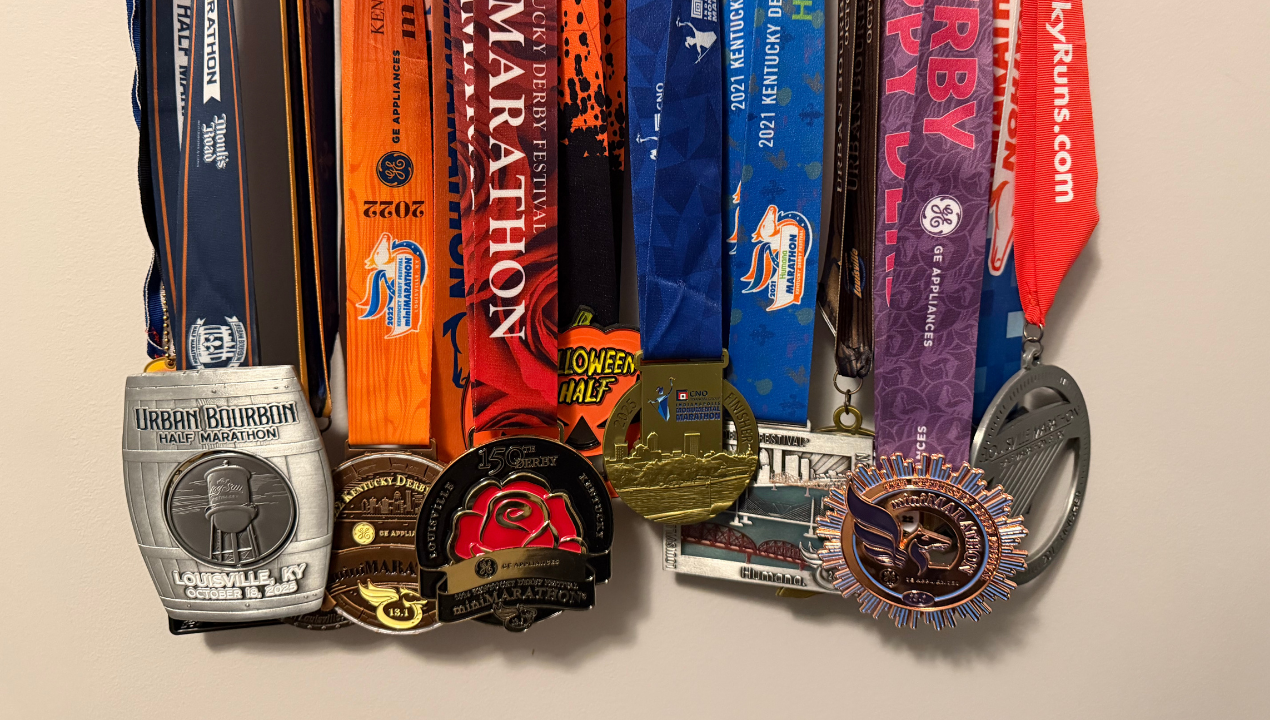 Daniel's large collection of race medals hang on display