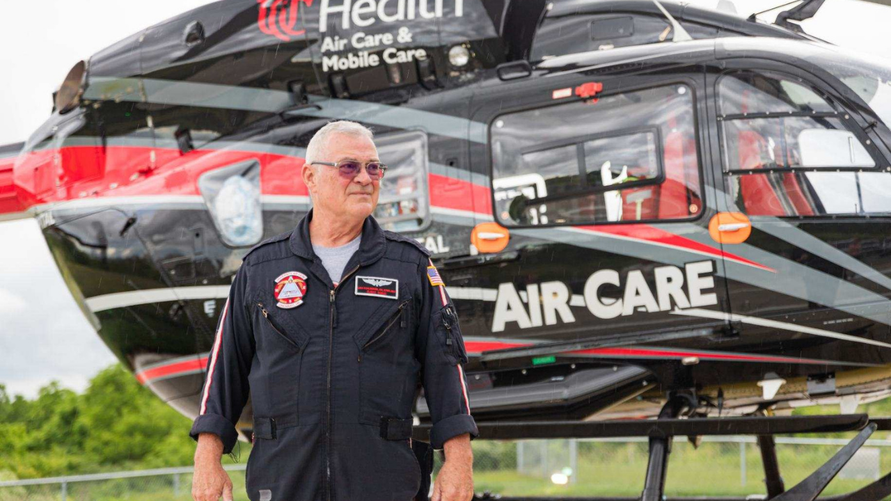 Dennis Schmidt stands in front of the UC Health Air Care helicopter during his time as a flight nurse.