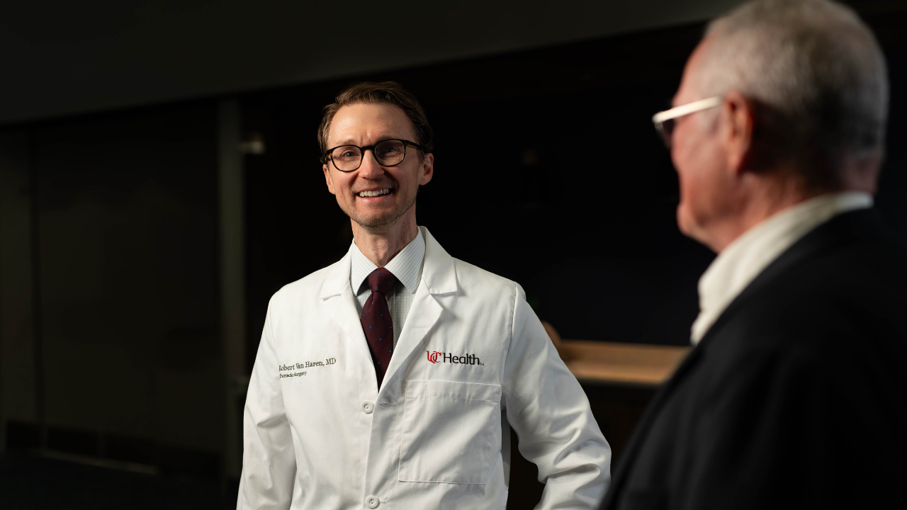 Dr. Van Haren smiles while talking with Dennis