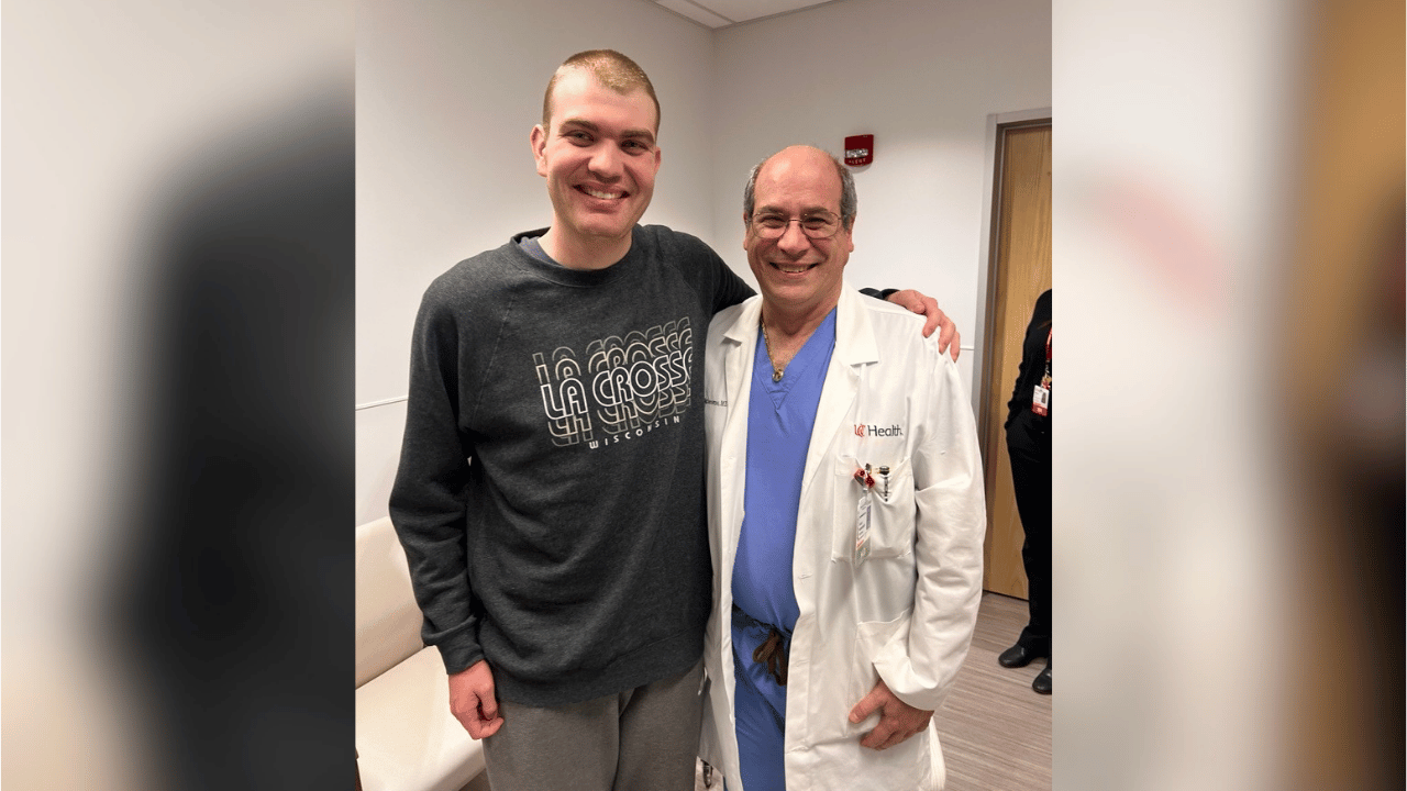 EJ and Dr. Prestigiacomo smile for a photo during his recovery process