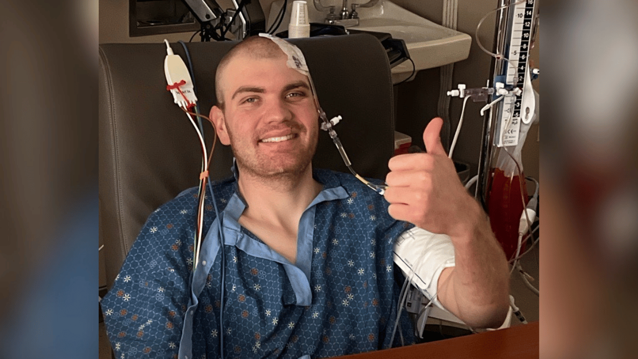 EJ gives a thumbs up from hospital bed