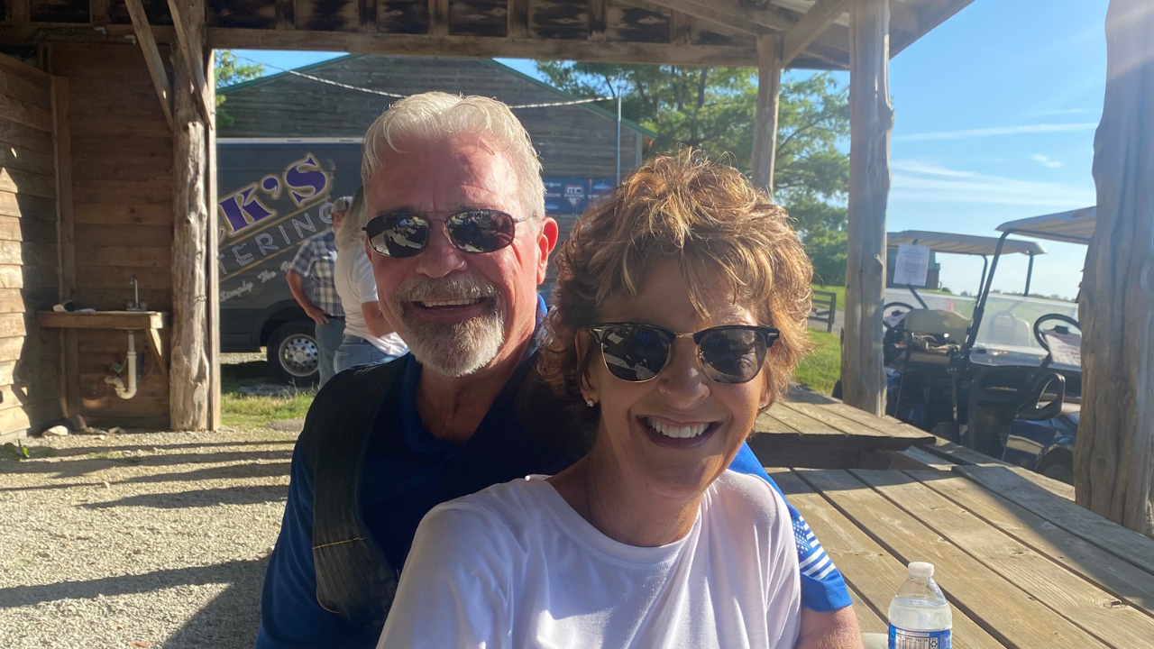David and Bonnie in the sun at a picnic table