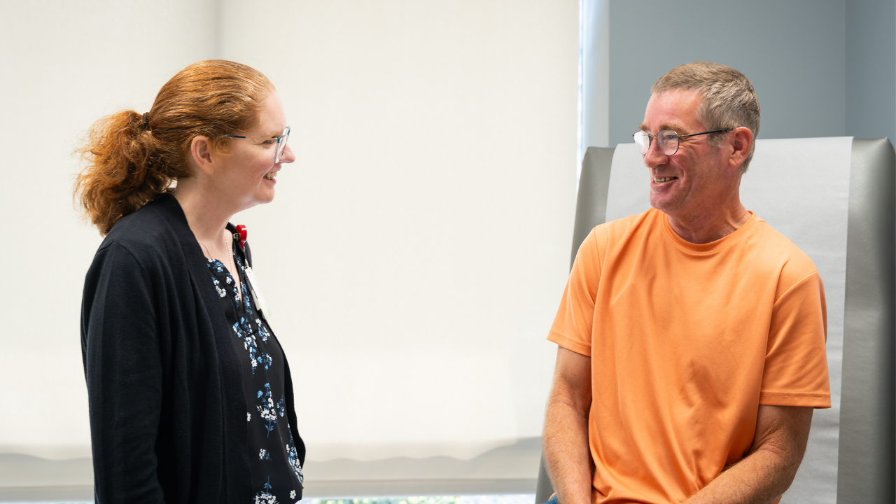 Dr. Jennifer Leddon smiles with patient, Jeff, during an exam at the University of Cincinnati Cancer Center.