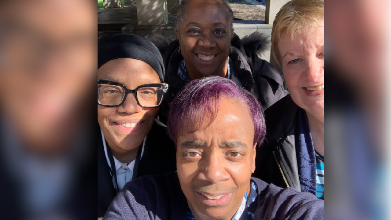 Kim and her friends smile for a selfie