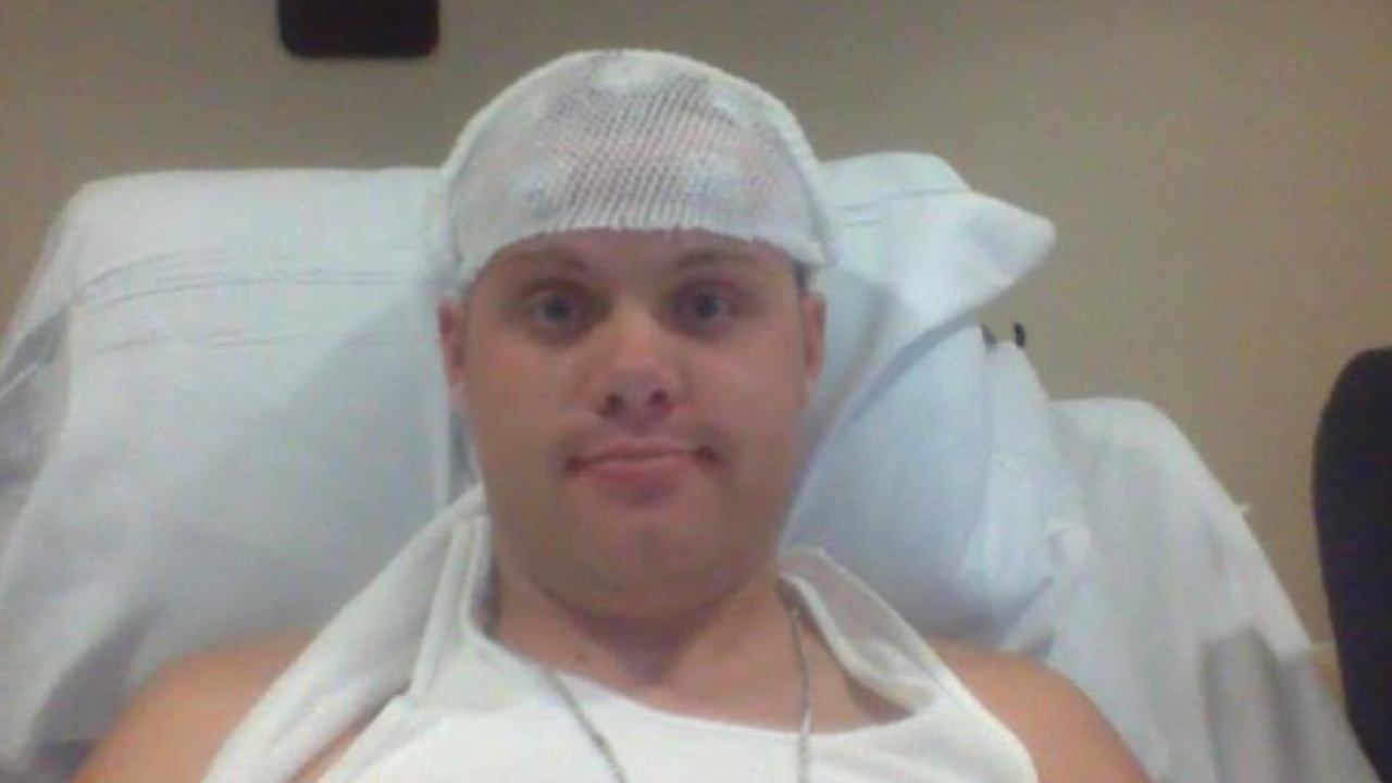 Kurtis laying on a hospital bed