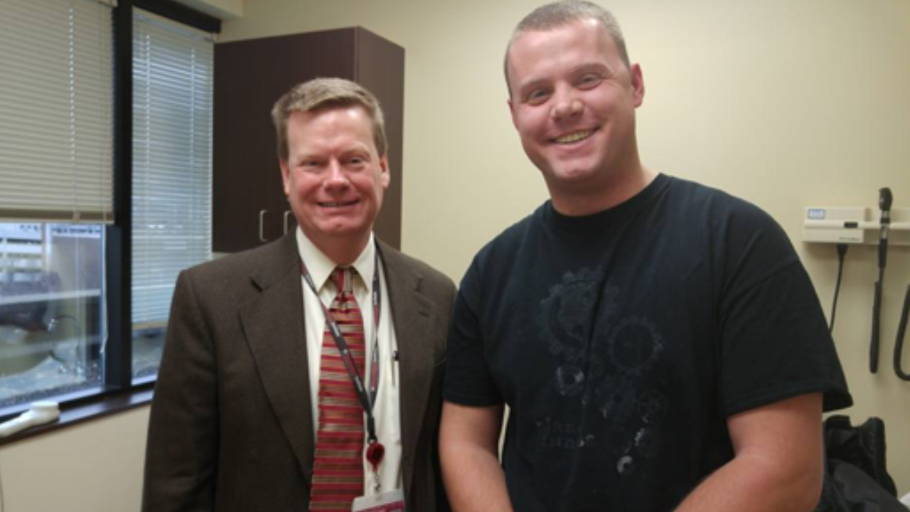 Kurtis and Dr. Ficker smile together during an appointment