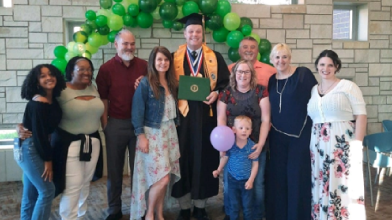 Kurtis celebrating graduation with his loved ones