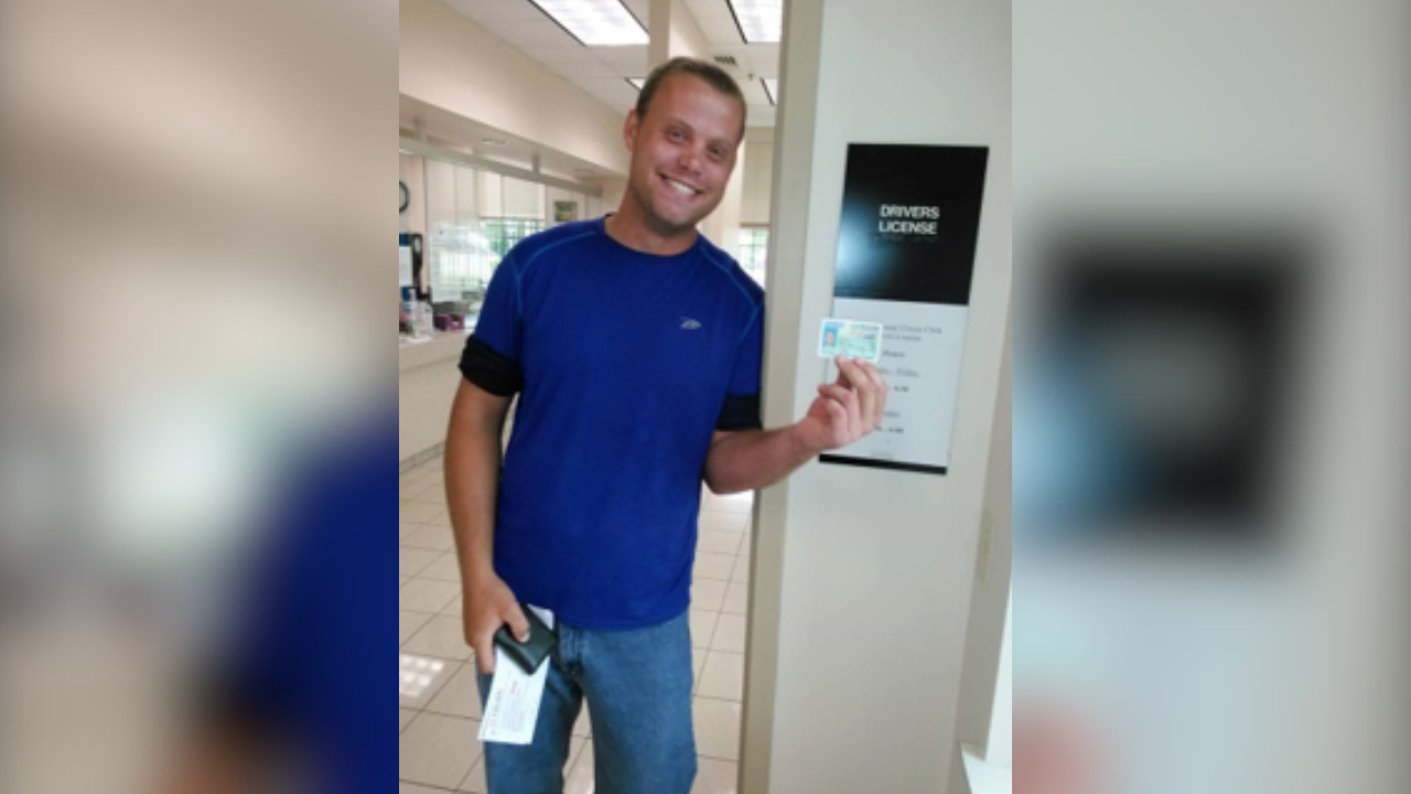 Kurtis smiles with his driver's license
