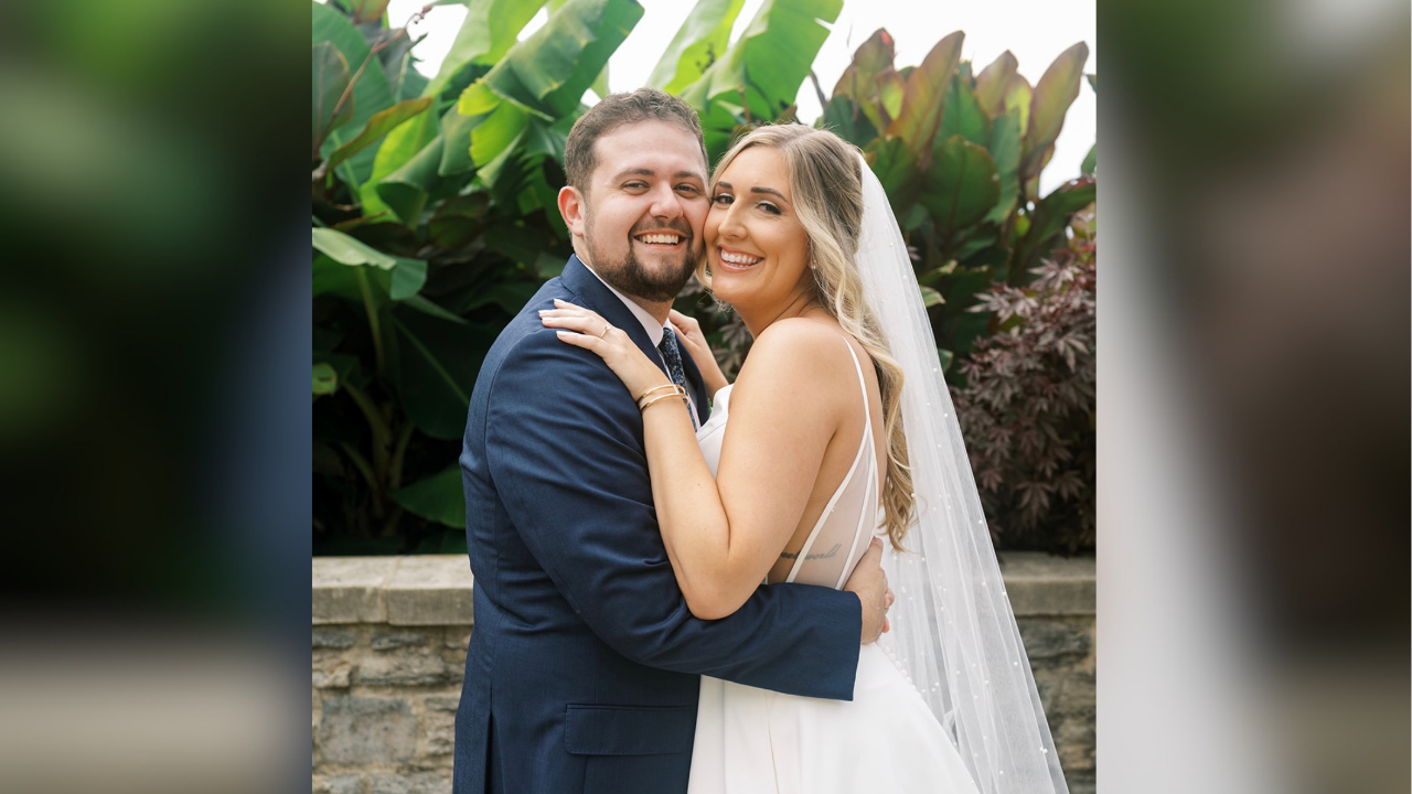 Mason and Hannah give big smiles for the camera on their wedding day.