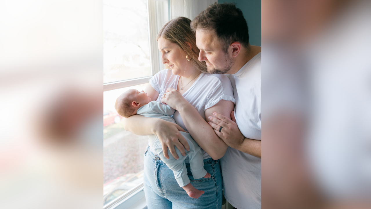Hannah and Mason gaze at baby Charlie at home
