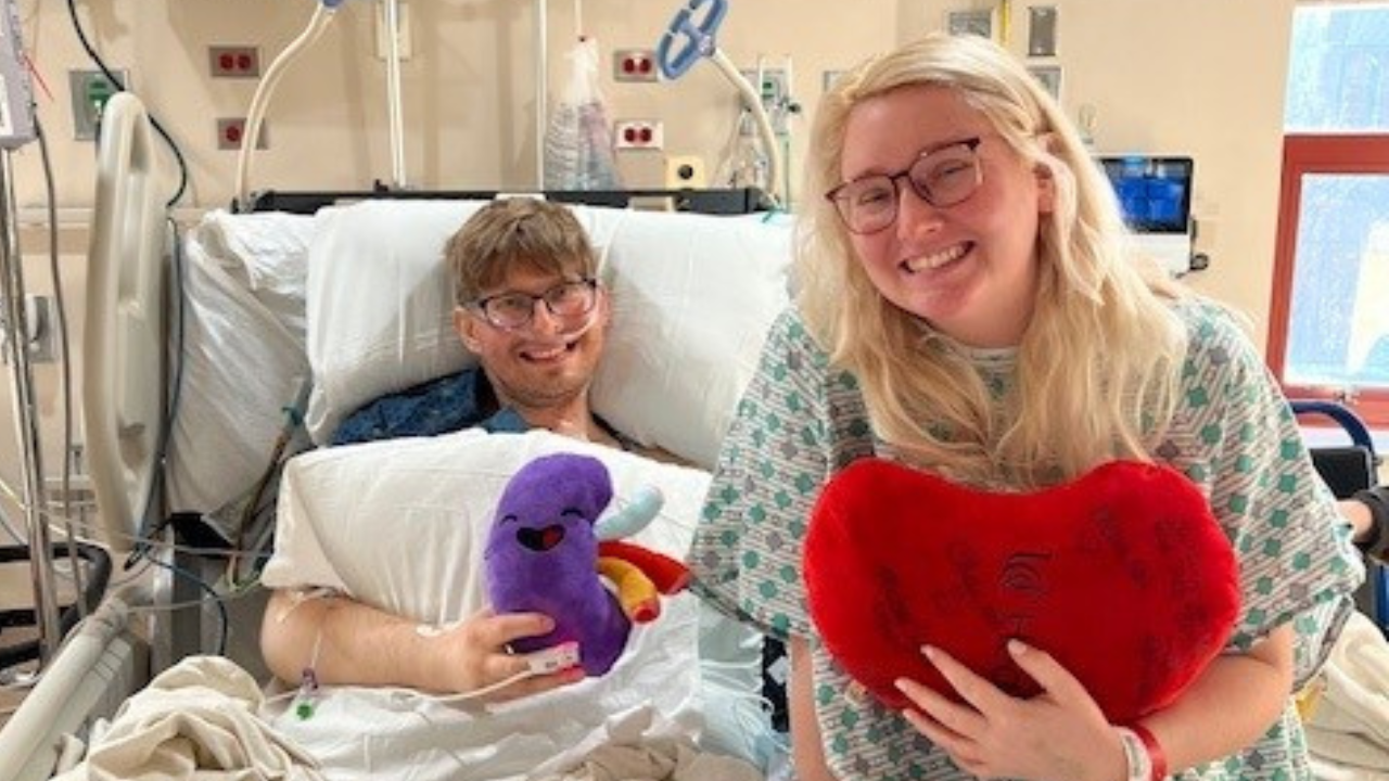 Jeremy and Hannah Maynard sit on a hospital bed after Jeremy's kidney transplant surgery at UC Health