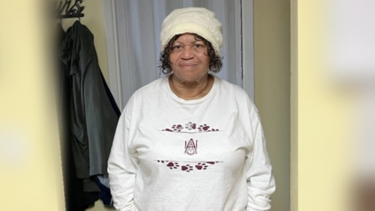 Roslyn stands in a doorway ready to exercise. 