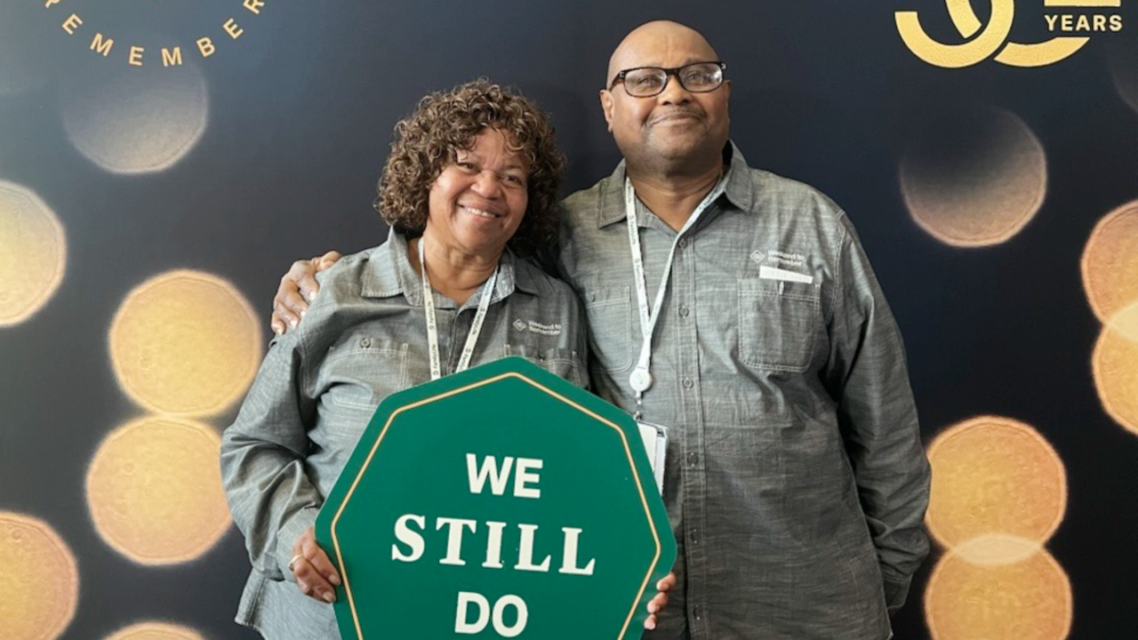 Roslyn stands next to her husband at a marriage conference. 