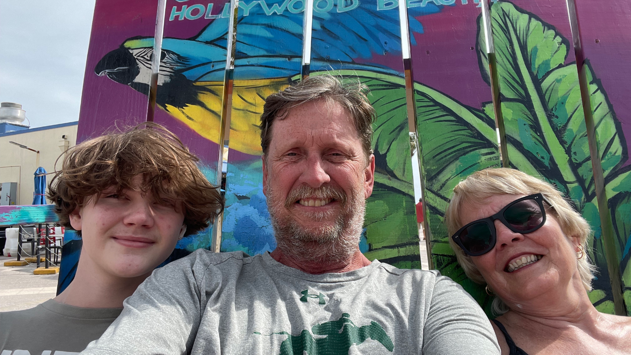 Steve smiles for a selfie with his family while on vacation
