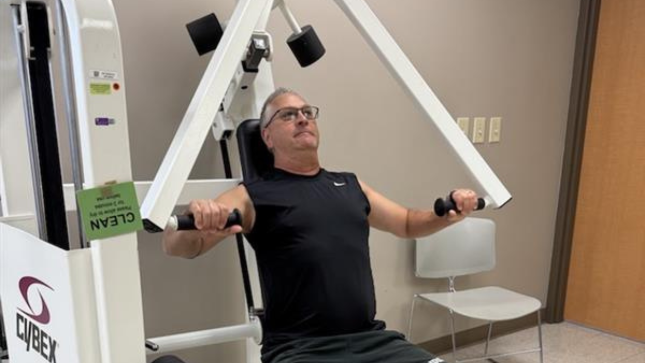 Steven Davis excercises on a machine as part of UC Health's Maintenance Exercise Program