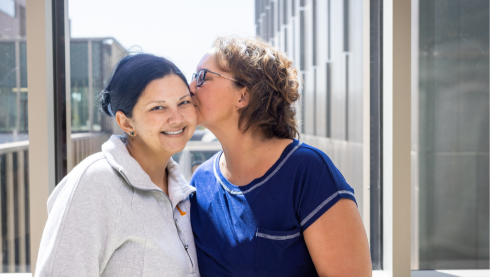 Trisha Wilhoit kisses her sister's cheek after surgery