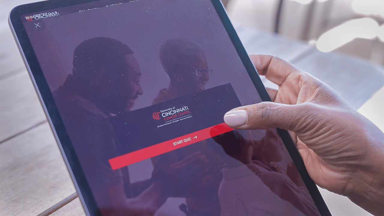 Woman uses an ipad to take the UC Cancer Center screening quiz