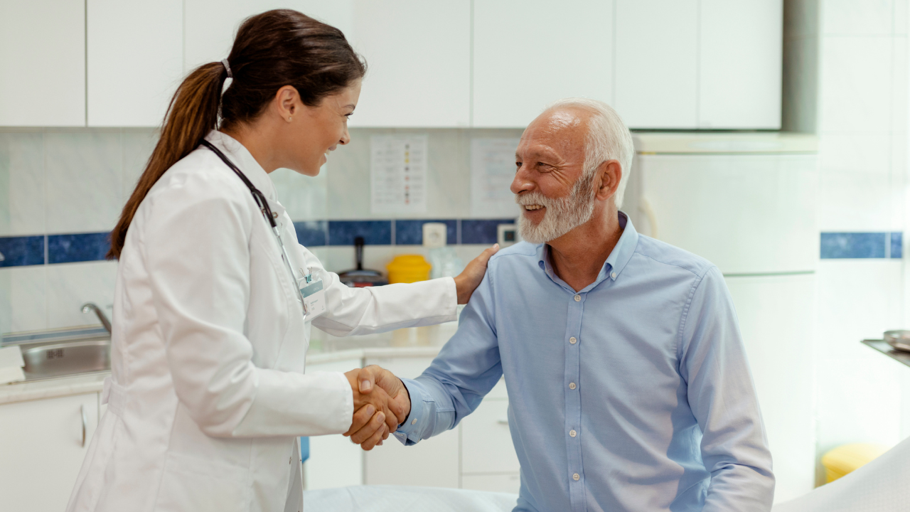 Patient and physician shake hands in medical setting