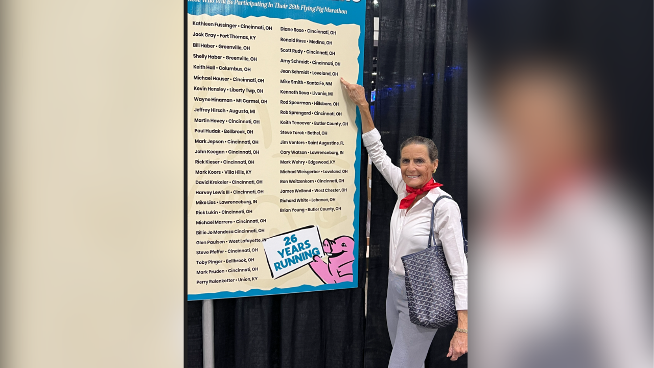 Jeans points out her name on the list of runners running their 26th Flying Pig Marathon in May 2024.  