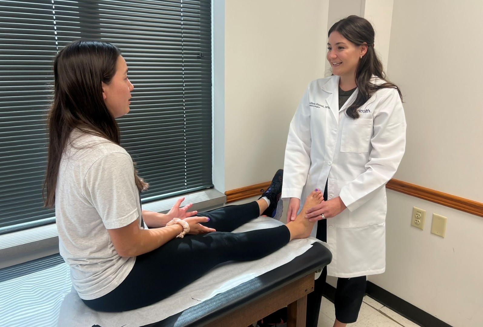 Dr. Hamad examines a patient's ankle and foot.