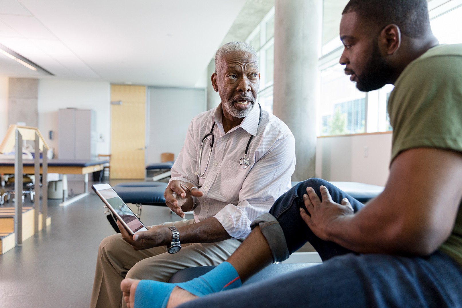 Physician talks with a patient in a medical environment. 