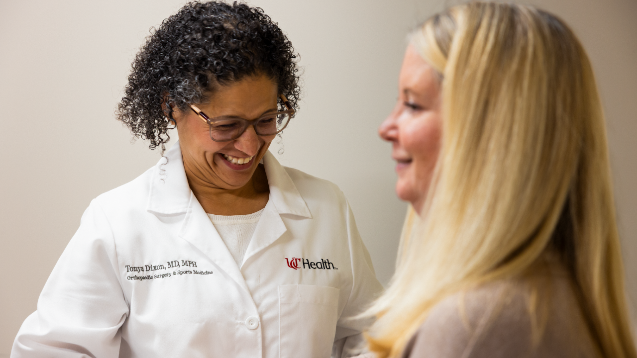 Dr. Dixon smiles with a patient during an appointment through UC Health's Women's Sports Medicine