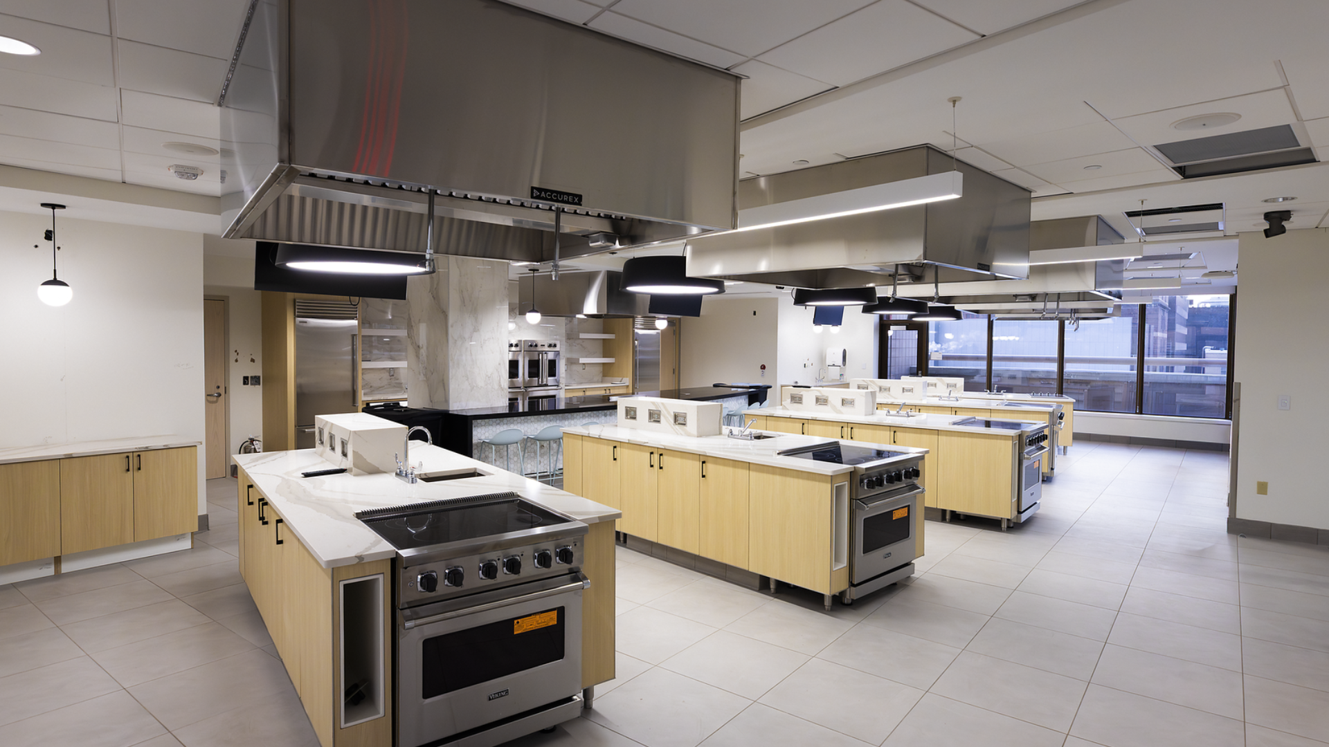At the UC Osher Wellness Suite, the Learning Kitchen features individual cooking stations designed for hands-on learning, with big countertops and seating around a central bar that encourages conversation and connection.
