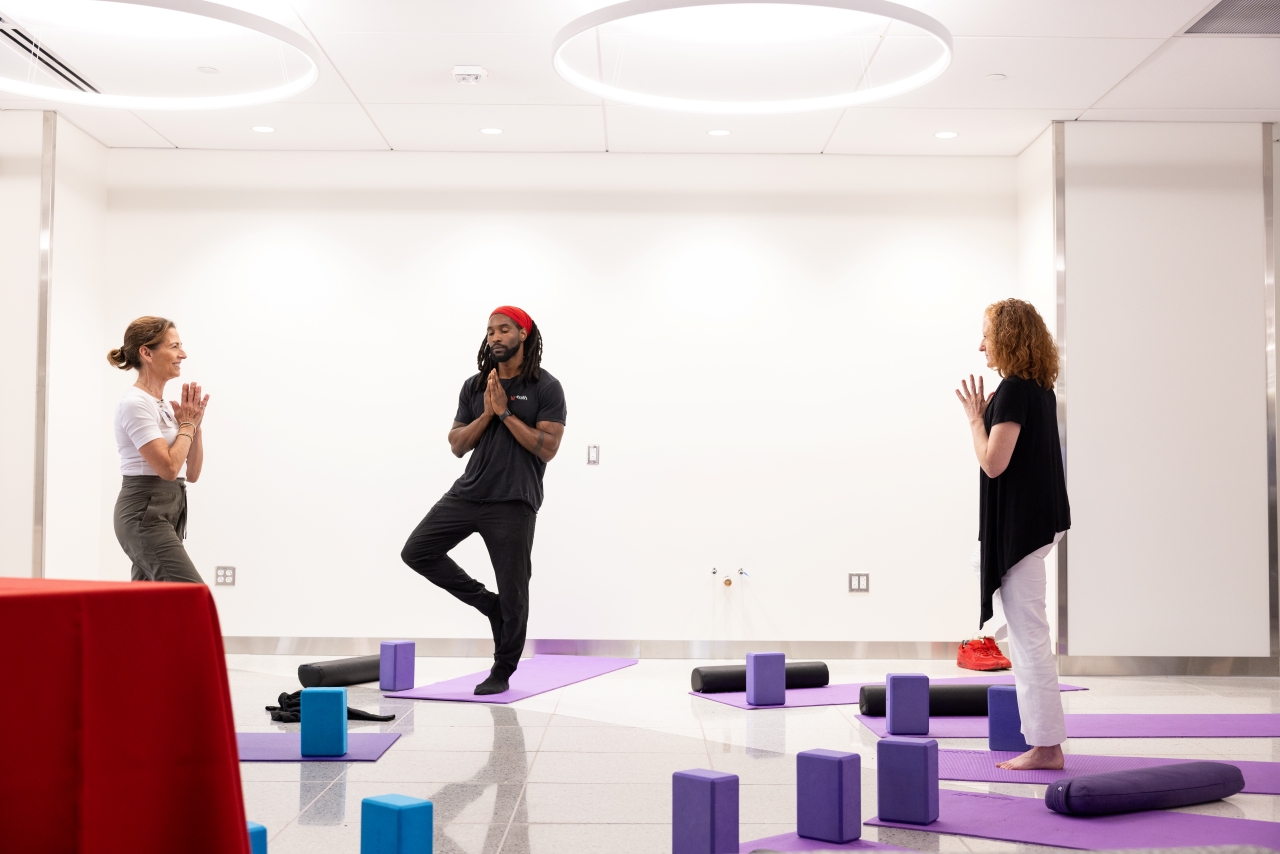 A therapist leads a class in yoga therapy.