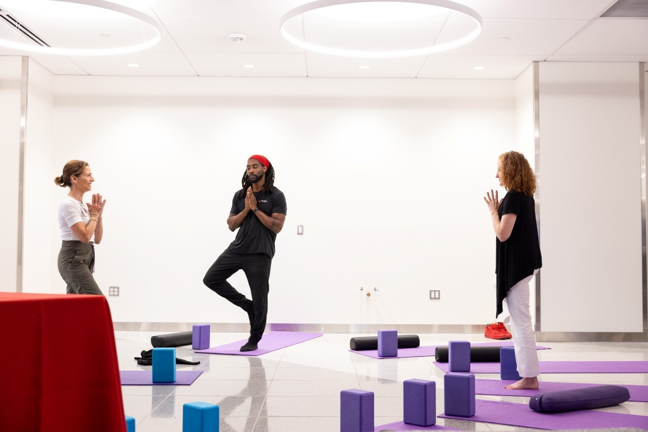 A therapist leads a class in yoga therapy.