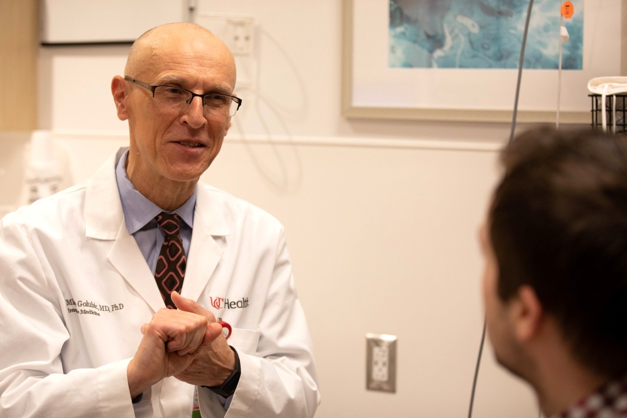 Dr. Golubic talks with a patient in an exam room.