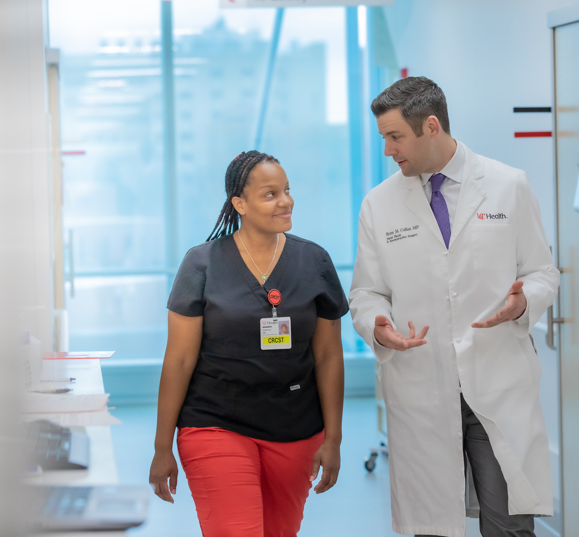 Physician and medical professional walking in a hall in a medical environment. 