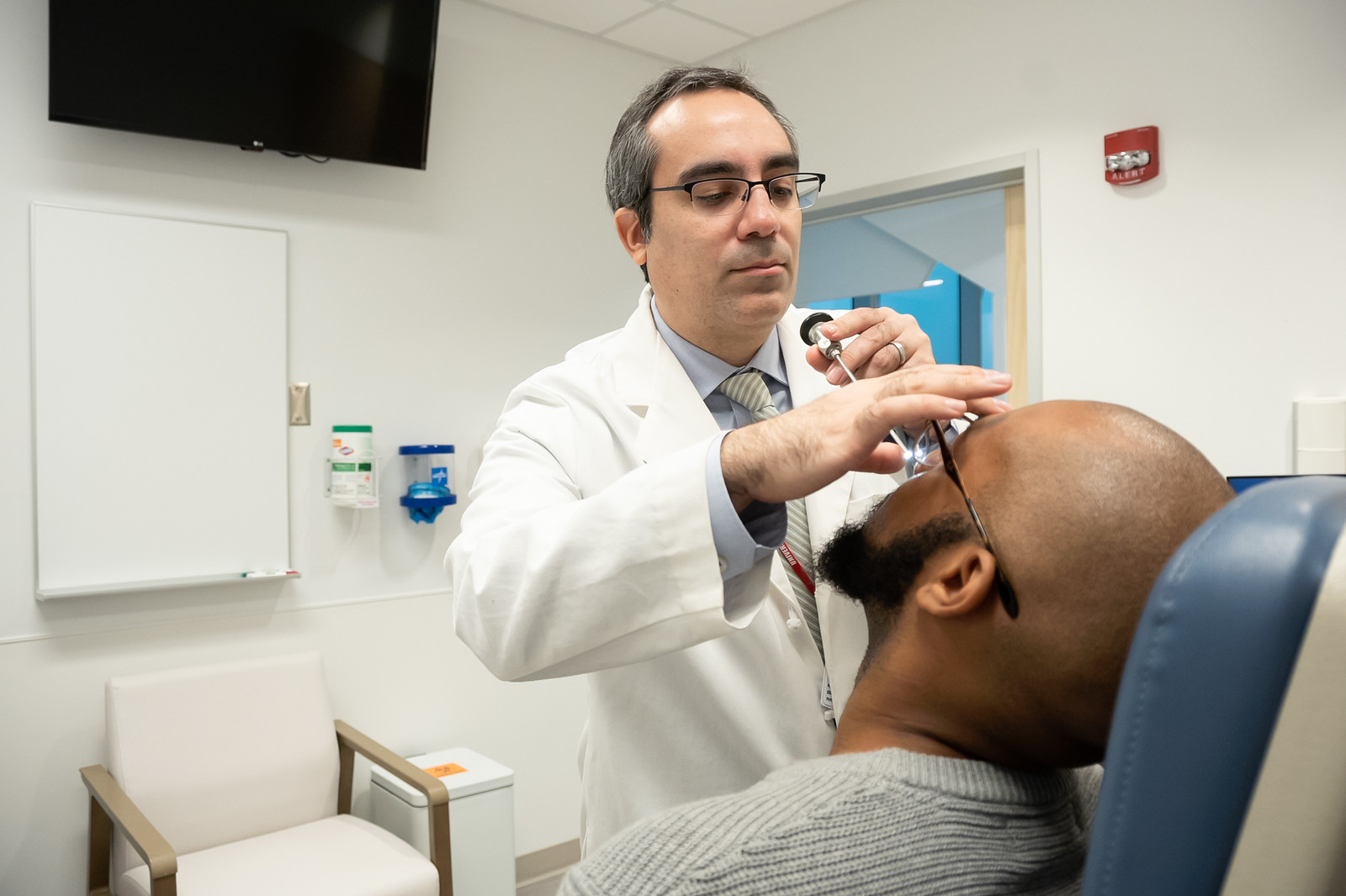 Physician performs sinus procedure on patient
