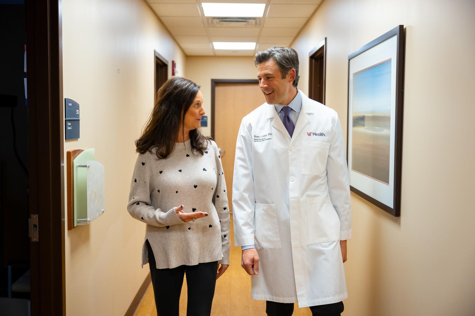 Dr. Collar walks with a patient at UC Health's Facial Plastics office in Cincinnati, Ohio