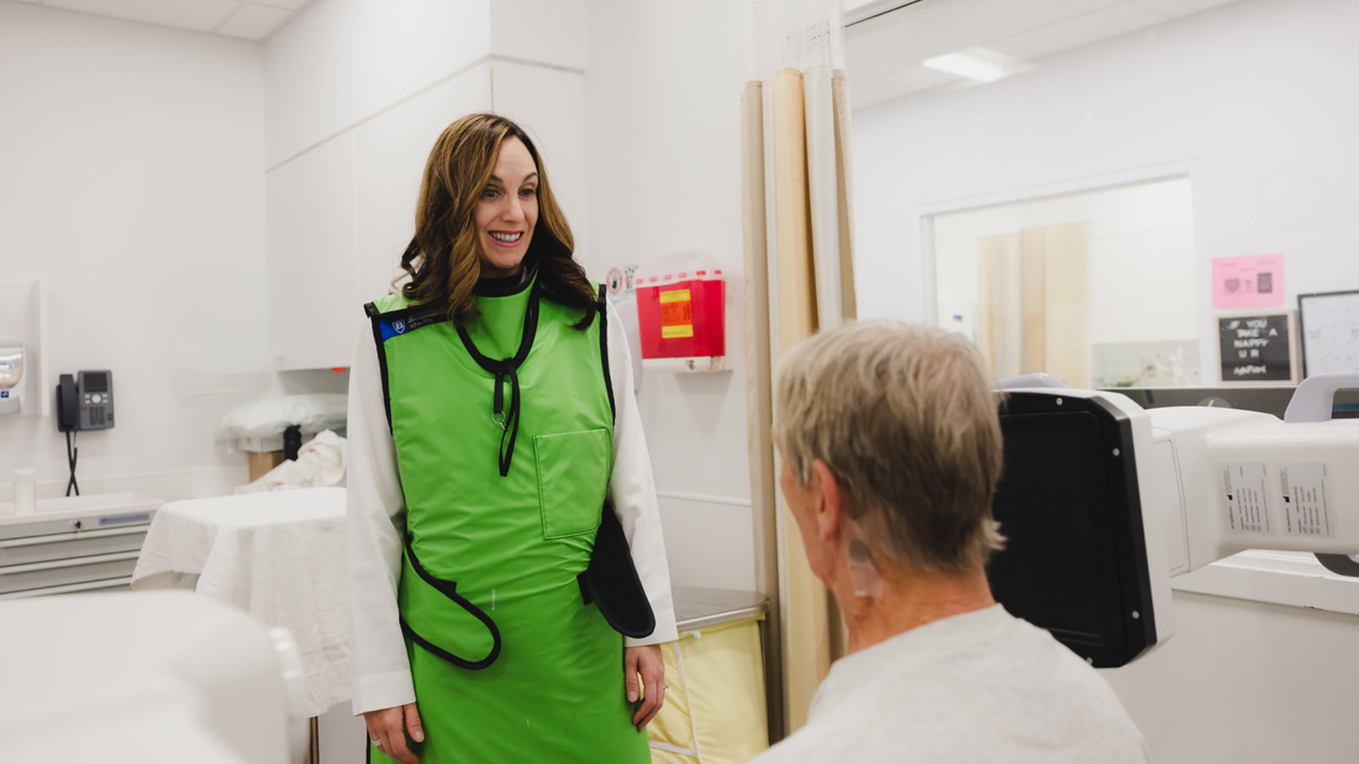 Physician and patient talking in a medical setting.
