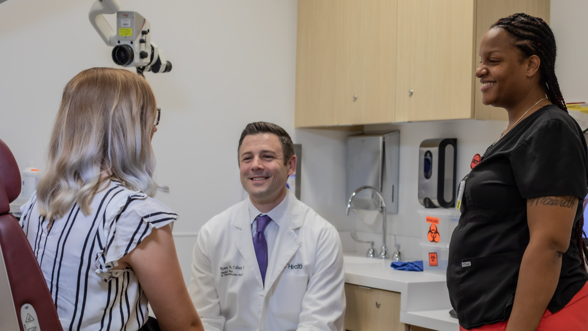 Dr. Collar talks with a patient in a medical setting.