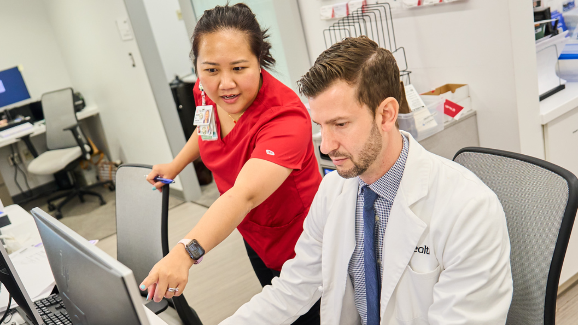UC Health team reviews a patient's information on a computer in medical setting
