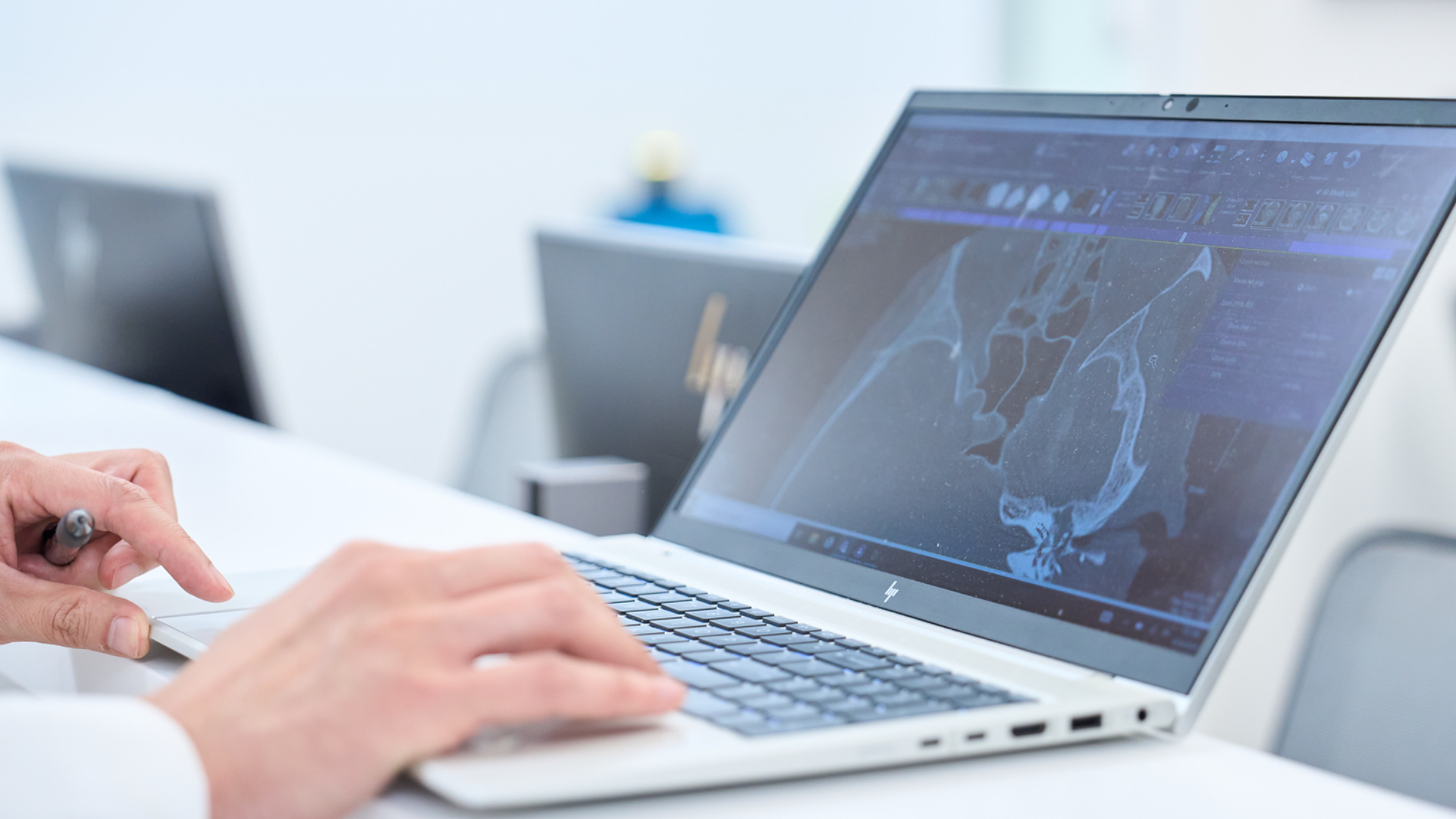 Physician using computer to evaluate ear