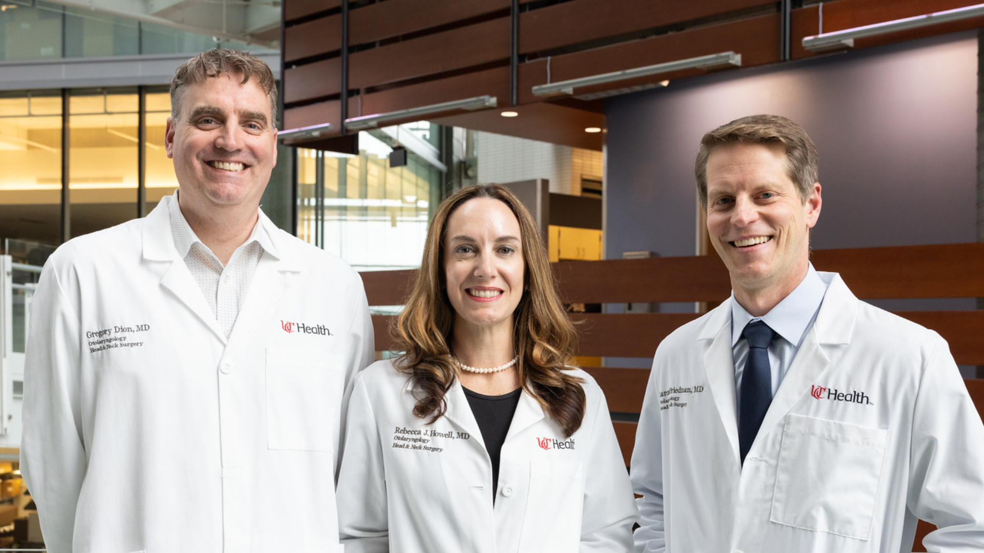 Dr. Dion, Dr. Howell, and Dr. Friedman smile for a photo at UC Health
