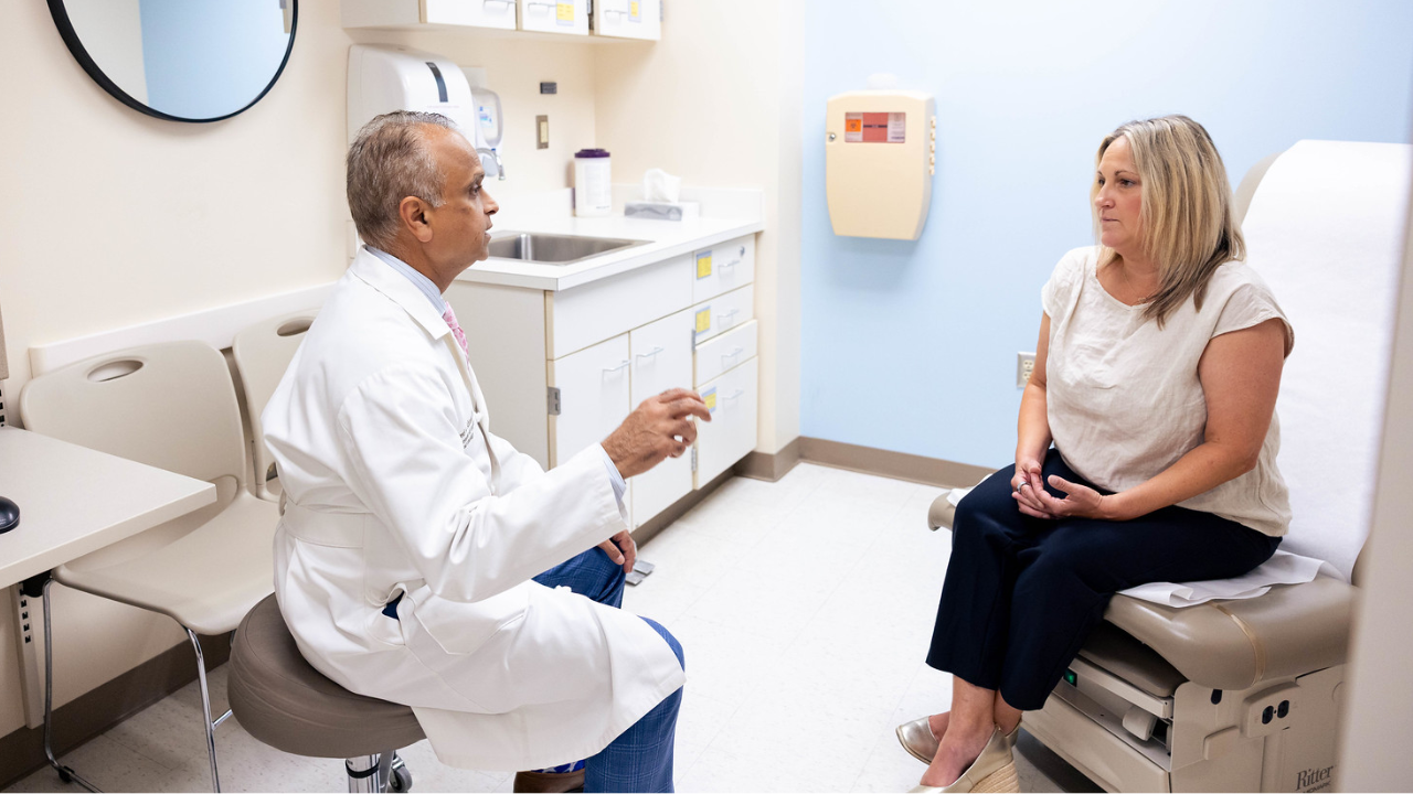 Dr. Syed Ahmad meets with a patient at UC Health in Cincinnati