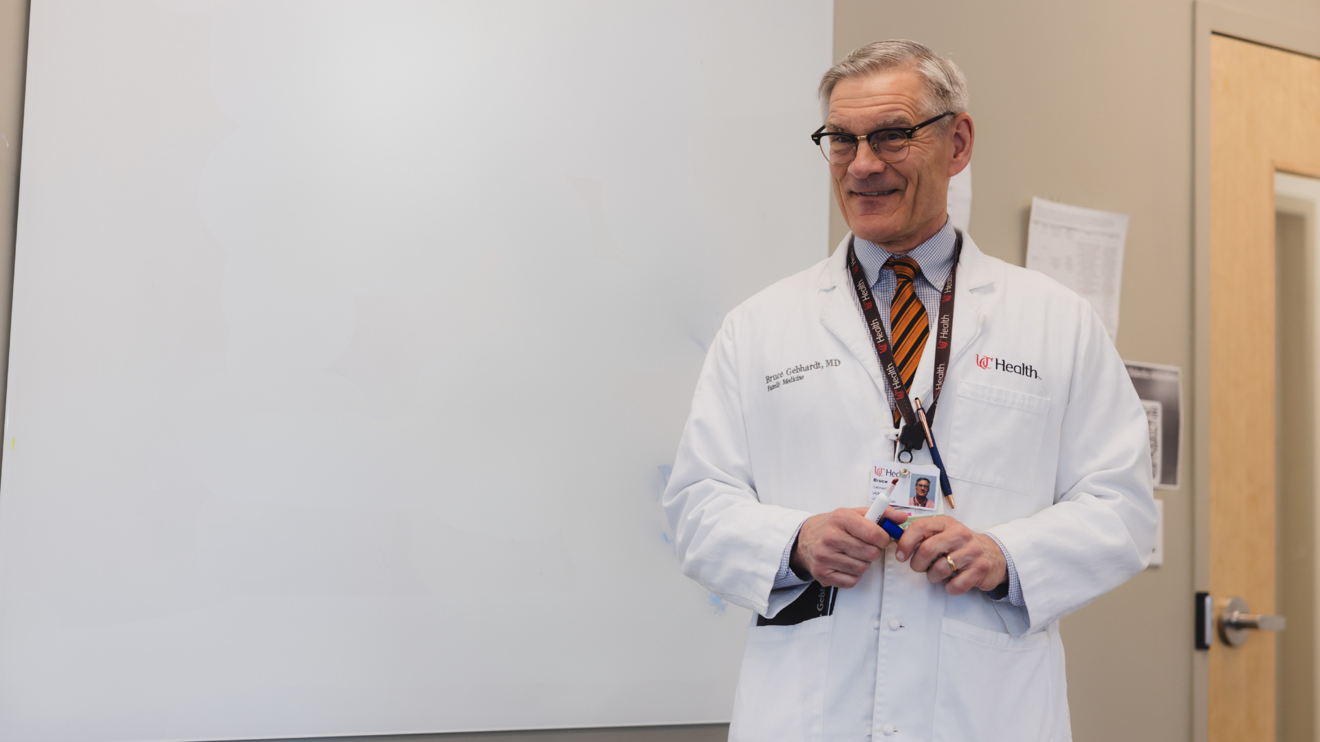 Dr. Gebhardt at UC Health standing in front of a whiteboard
